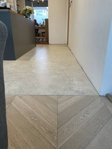 Tile to herringbone timber floor transition