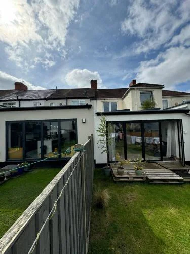 Completed rear extension with wide black framed glazing
